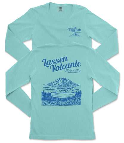 A light blue long-sleeved t-shirt with a graphic design depicting a mountain landscape and the text "Lassen Volcanic National Park" printed on the back.