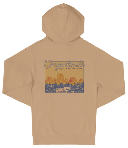 A beige hooded sweatshirt with a graphic design depicting a scenic landscape with mountains and water.
