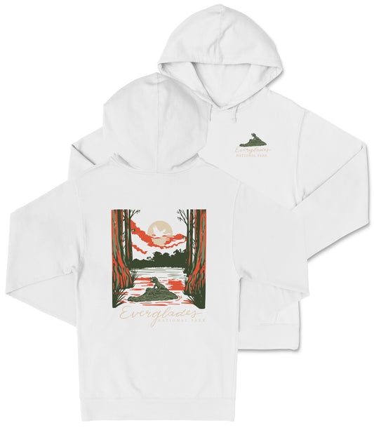 A white hooded sweatshirt with a graphic design depicting a scenic landscape with a lake, mountains, and trees.