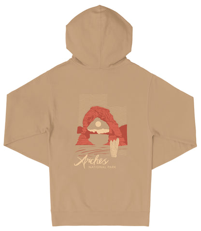 A beige hooded sweatshirt with a graphic design depicting a desert landscape, including a red arch and a cactus. The text "Arches National Park" is printed on the back of the sweatshirt.