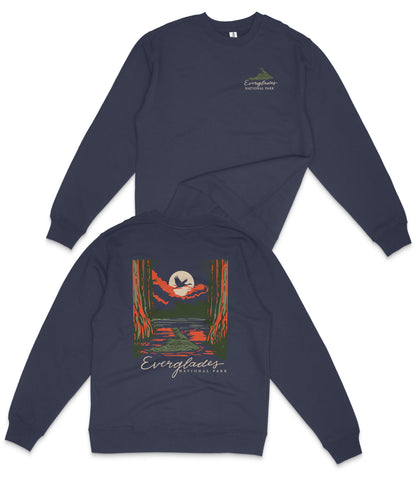 a navy blue sweatshirt with a graphic design on the back, depicting a sunset over a body of water.