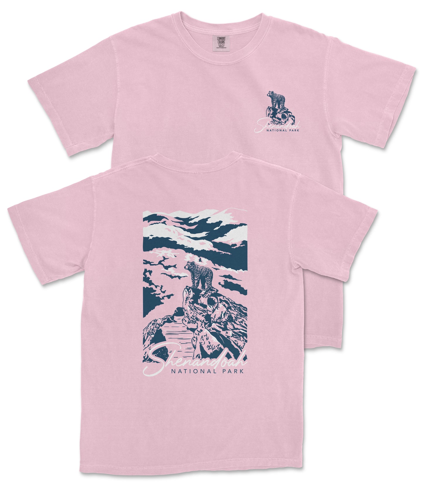 A pink t-shirt with a graphic design depicting a person riding a bicycle on a trail in a mountainous landscape, with the text "National Park" printed on it.