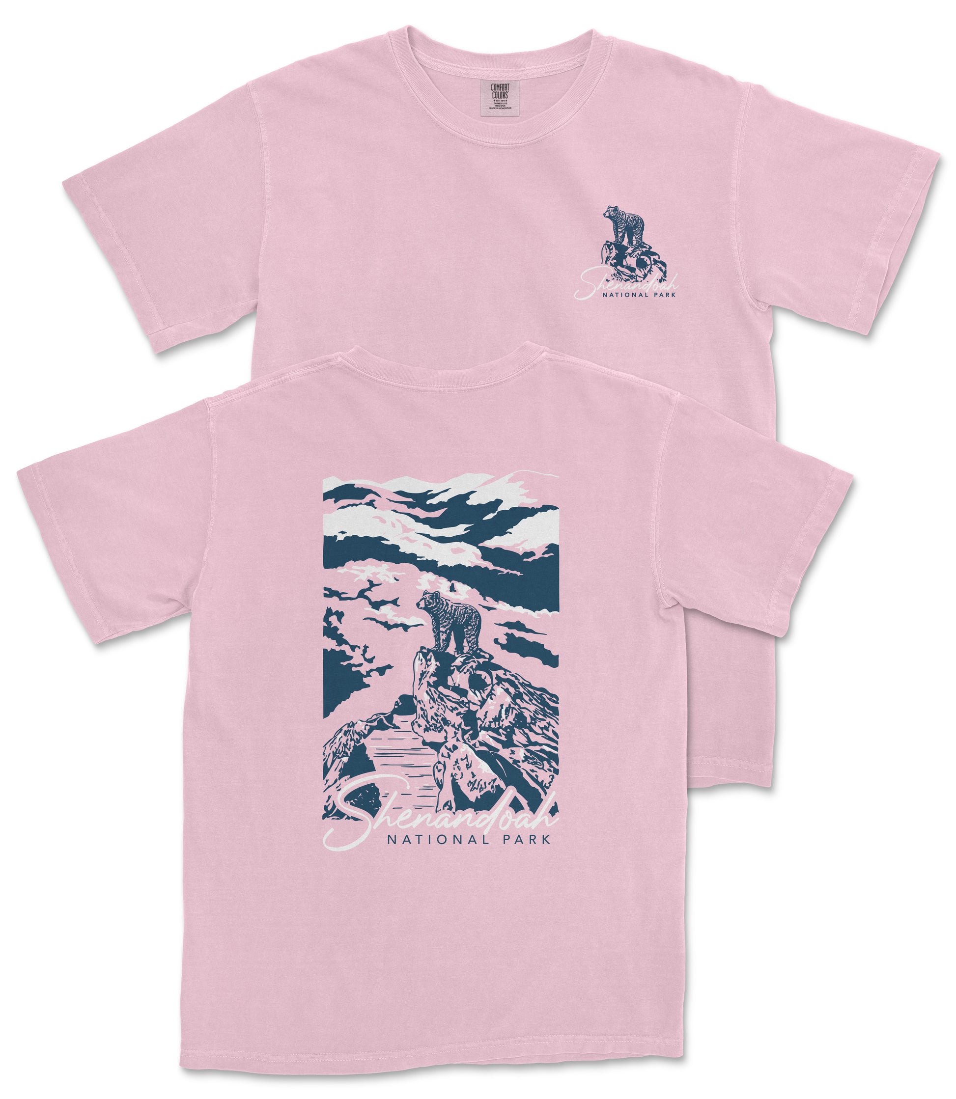 A pink t-shirt with a graphic design depicting a person riding a bicycle on a trail in a mountainous landscape, with the text "National Park" printed on it.