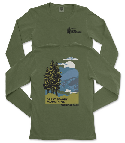 A green long-sleeved t-shirt with a graphic design depicting a mountain landscape with pine trees, a full moon, and clouds. The text on the t-shirt reads "Great Smoky Mountains National Park".
