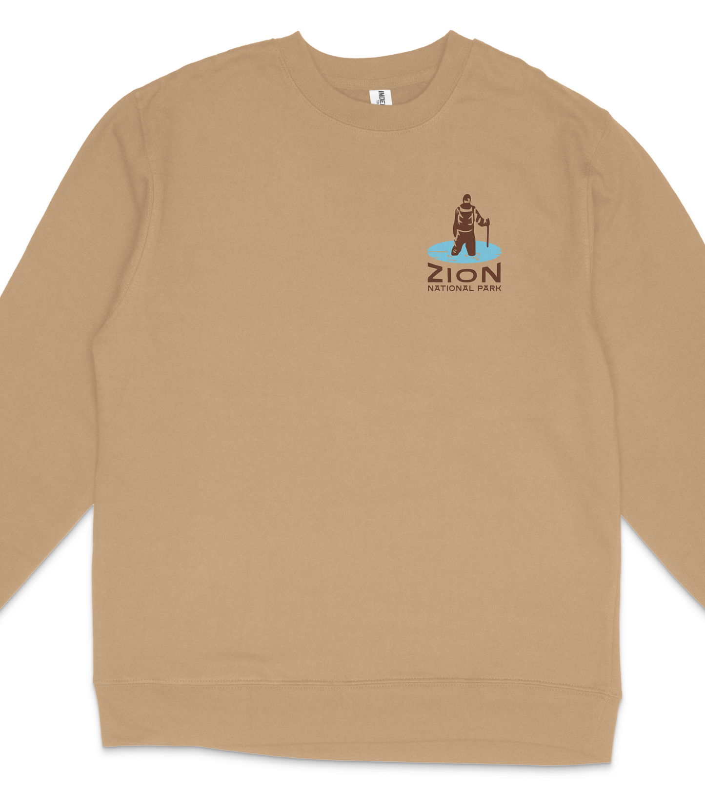 A tan long-sleeved shirt with a small logo on the left side depicting a person in a brown outfit.